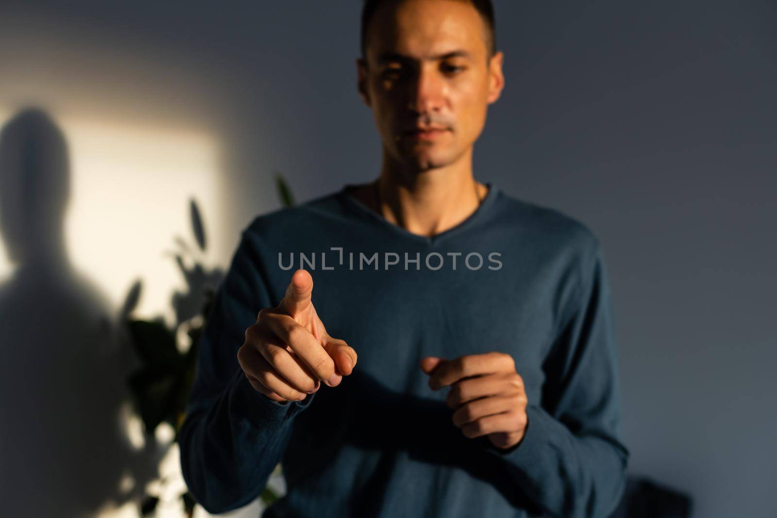 Young handsome man wearing casual t-shirt presenting with hand and pointing with finger. by Andelov13