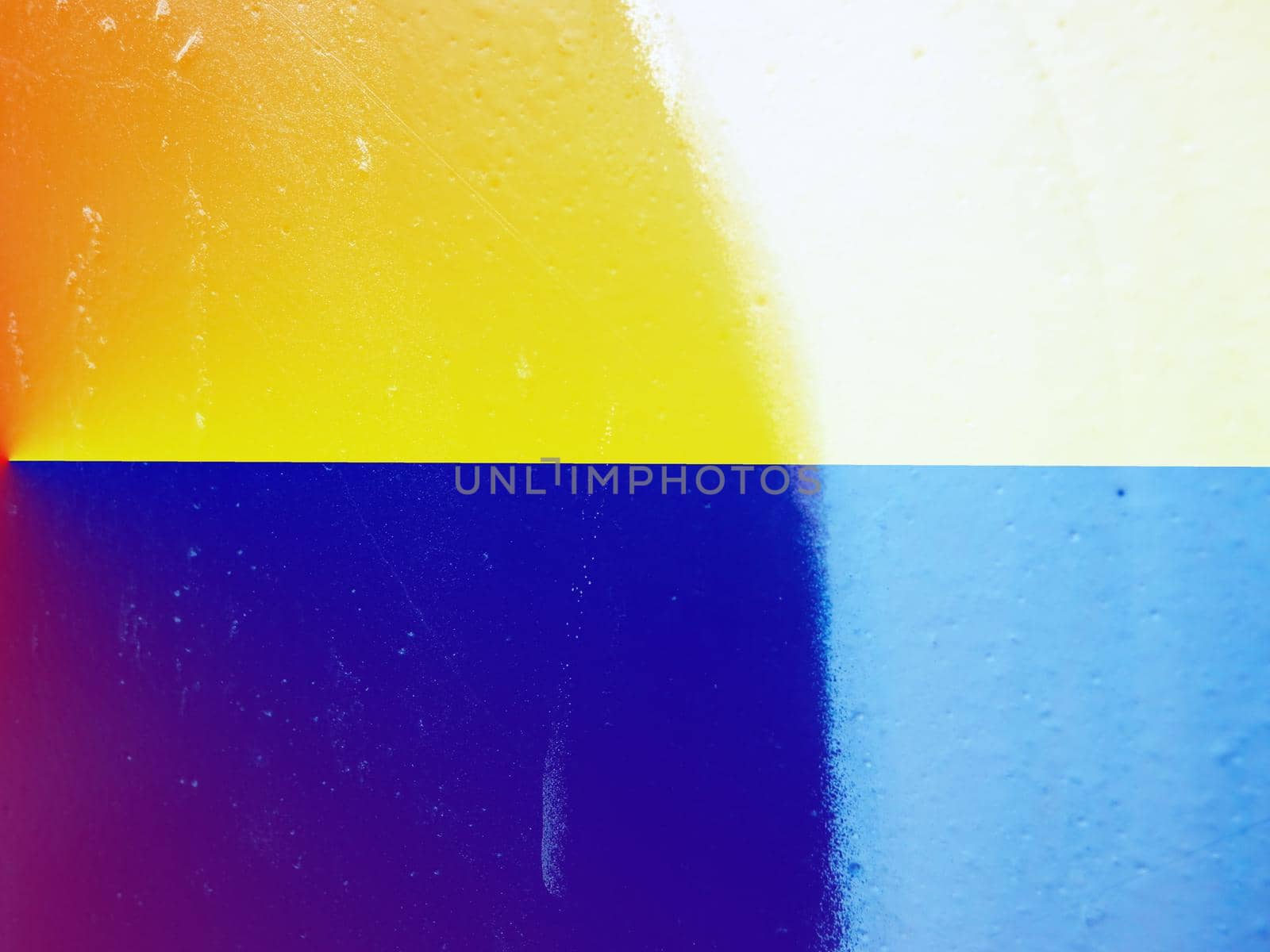 Closeup of colorful texture and background in Ukraine flag color - yellow and blue. Ukraine flag paint shading with image of national flag. Independence Day banner background style.