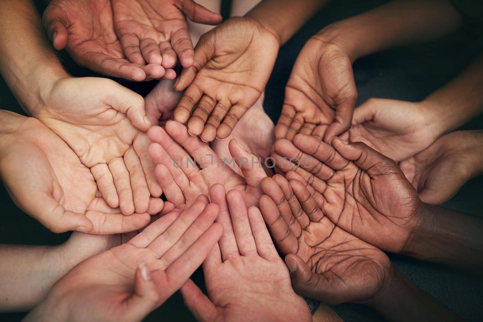 Let your hands do the talking. High angle shot of a group of unrecognizable peoples hands out with their palms open. by YuriArcurs