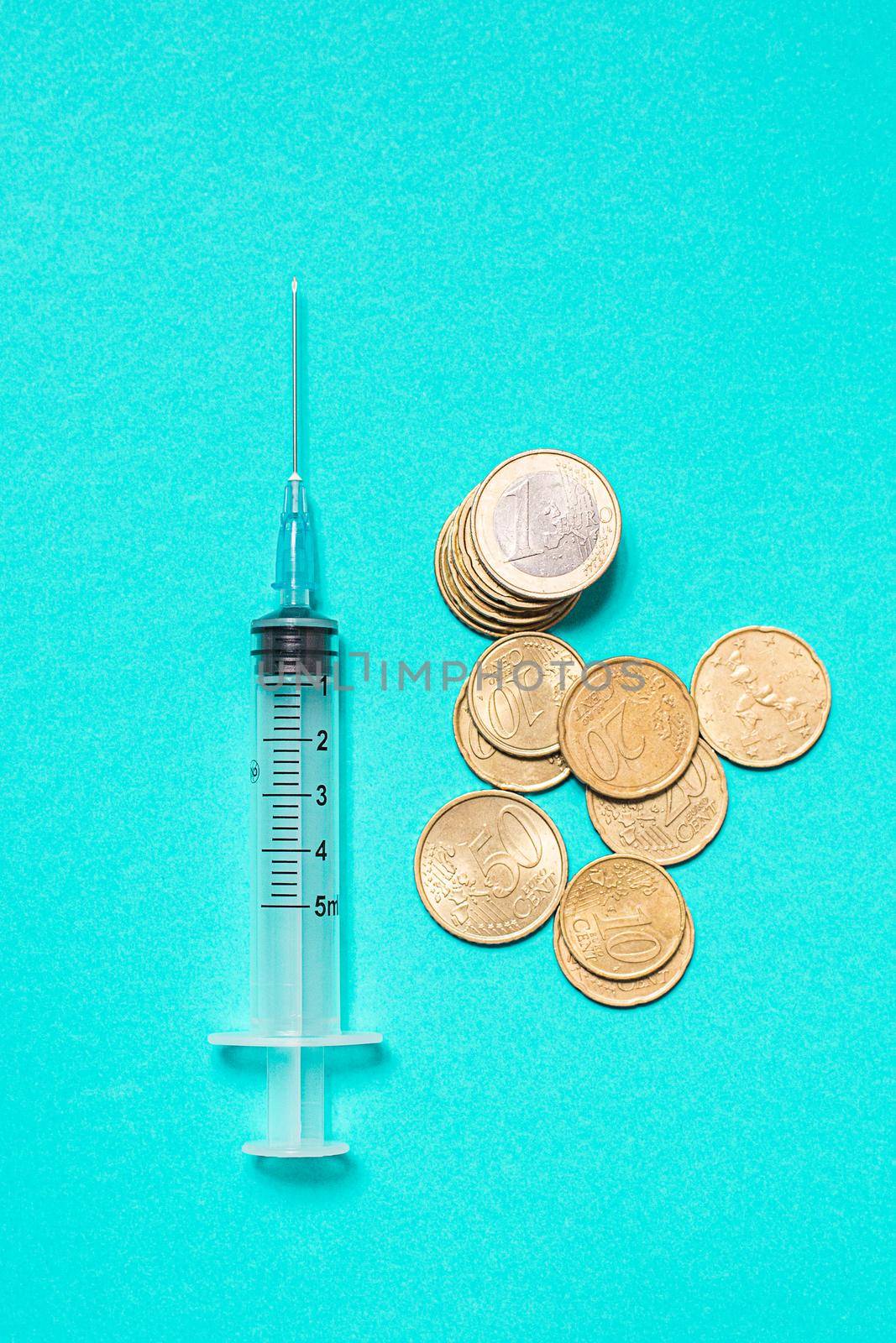 Syringe with vaccine on blue background from above by Ciorba