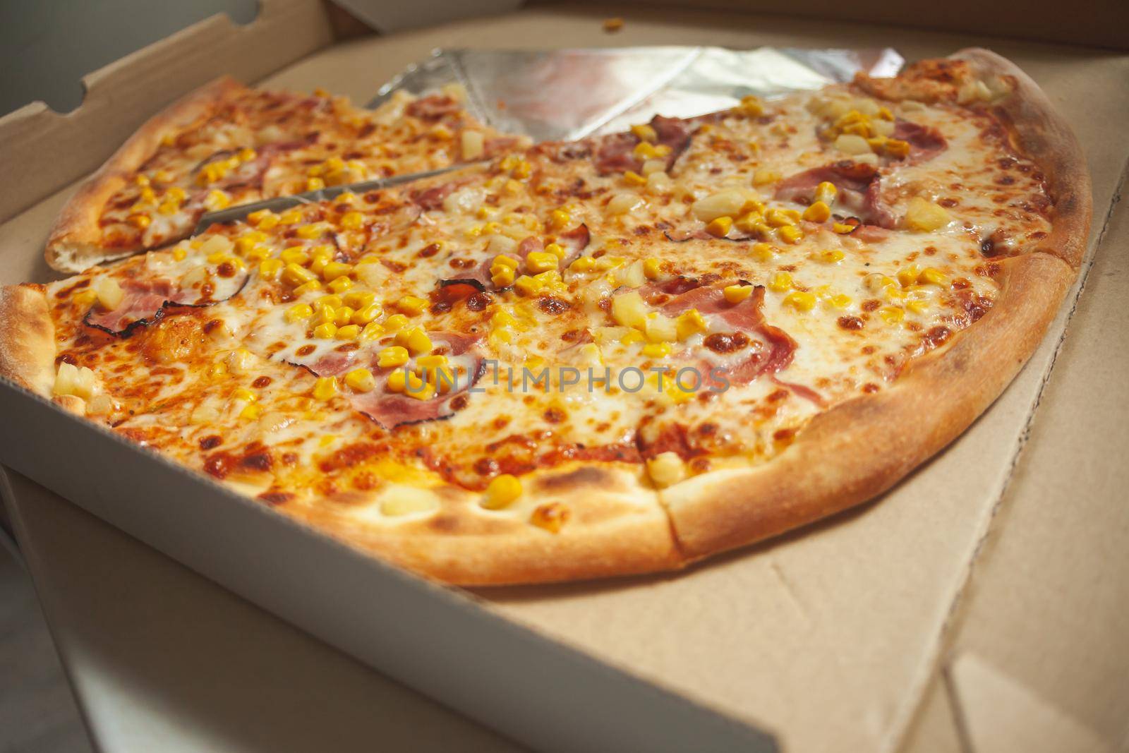 Large pizza pieces delivered in an open box