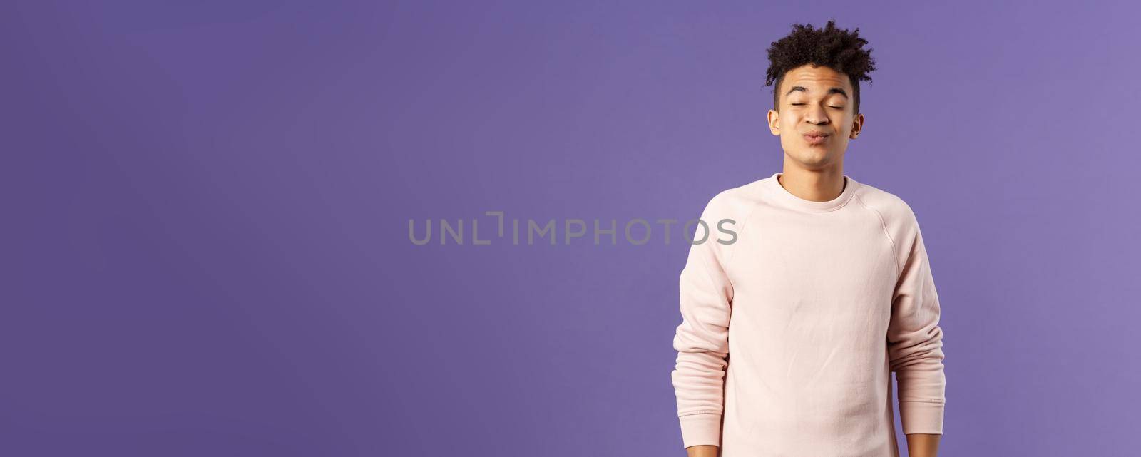 Portrait of cute and silly, young hispanic trying to kiss girl after date for the first time, leaning with folded lips and closed eyes towards her, making funny smile, standing purple background by Benzoix