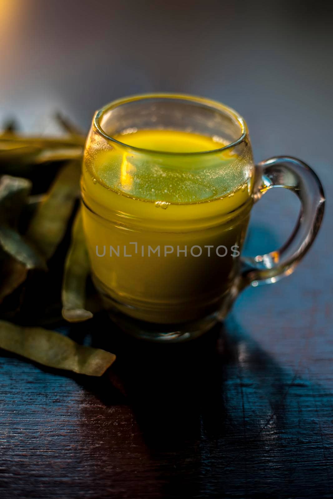 Shot of healthy nutritious organic Sponge gourd or luffa juice in a glass mug along ith some raw sponge gourd with it.