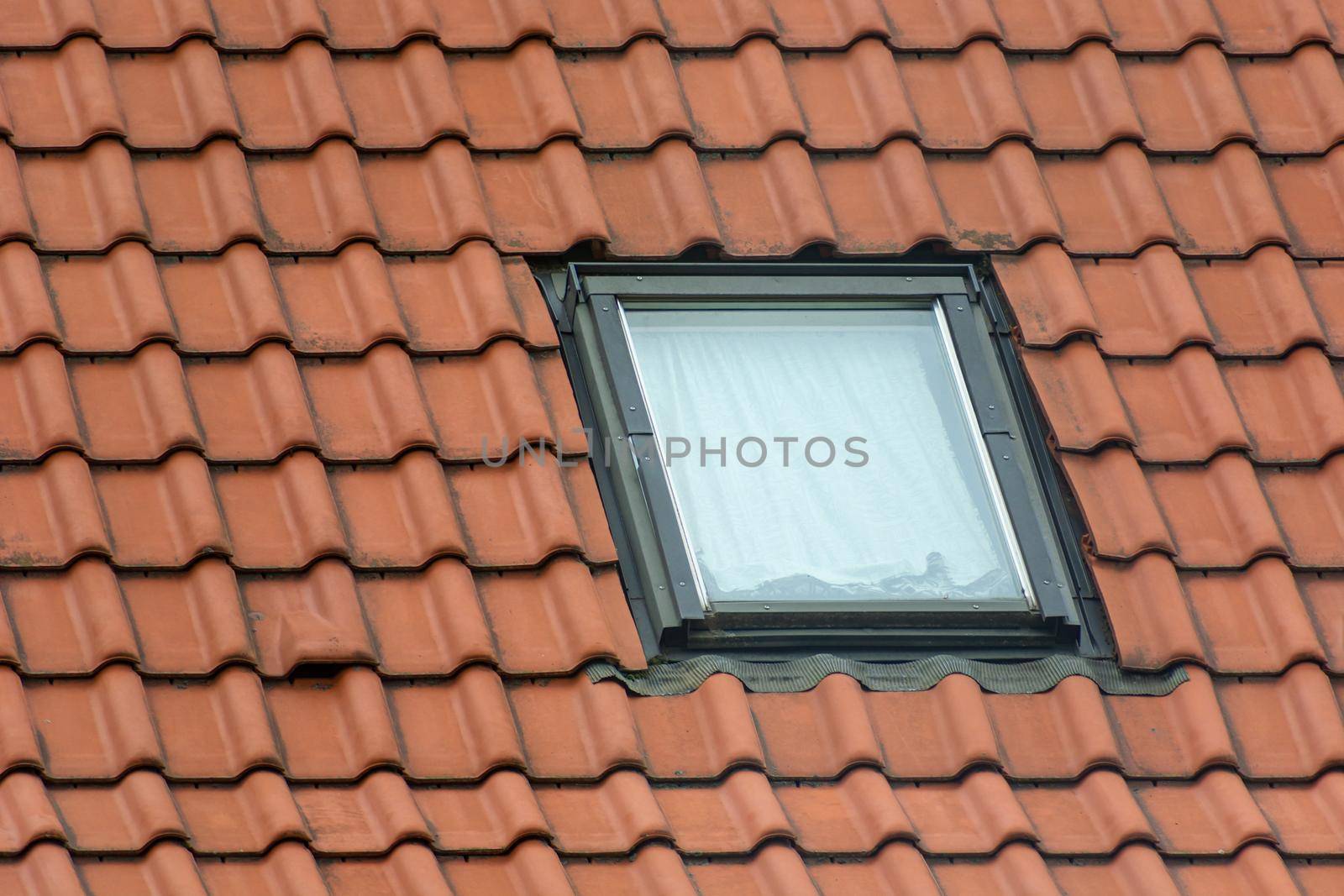 Small single window in the brown attic roof, Skylight in the roof