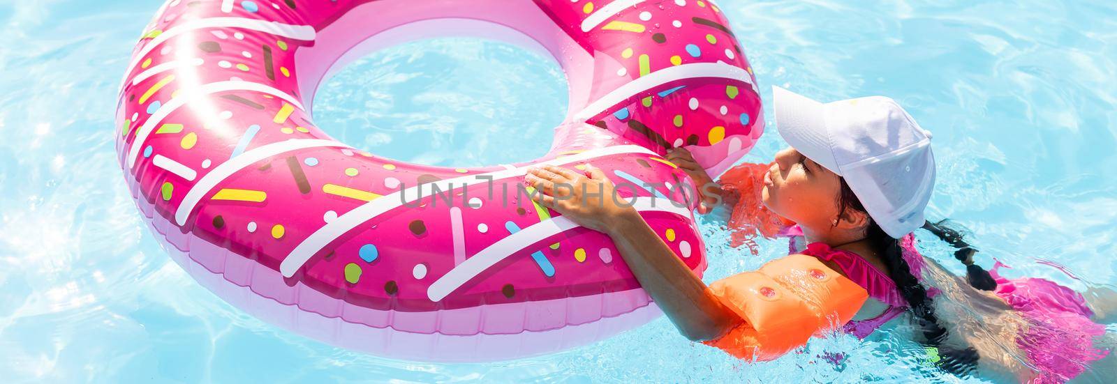 Happy child playing in swimming pool. Summer vacation concept.