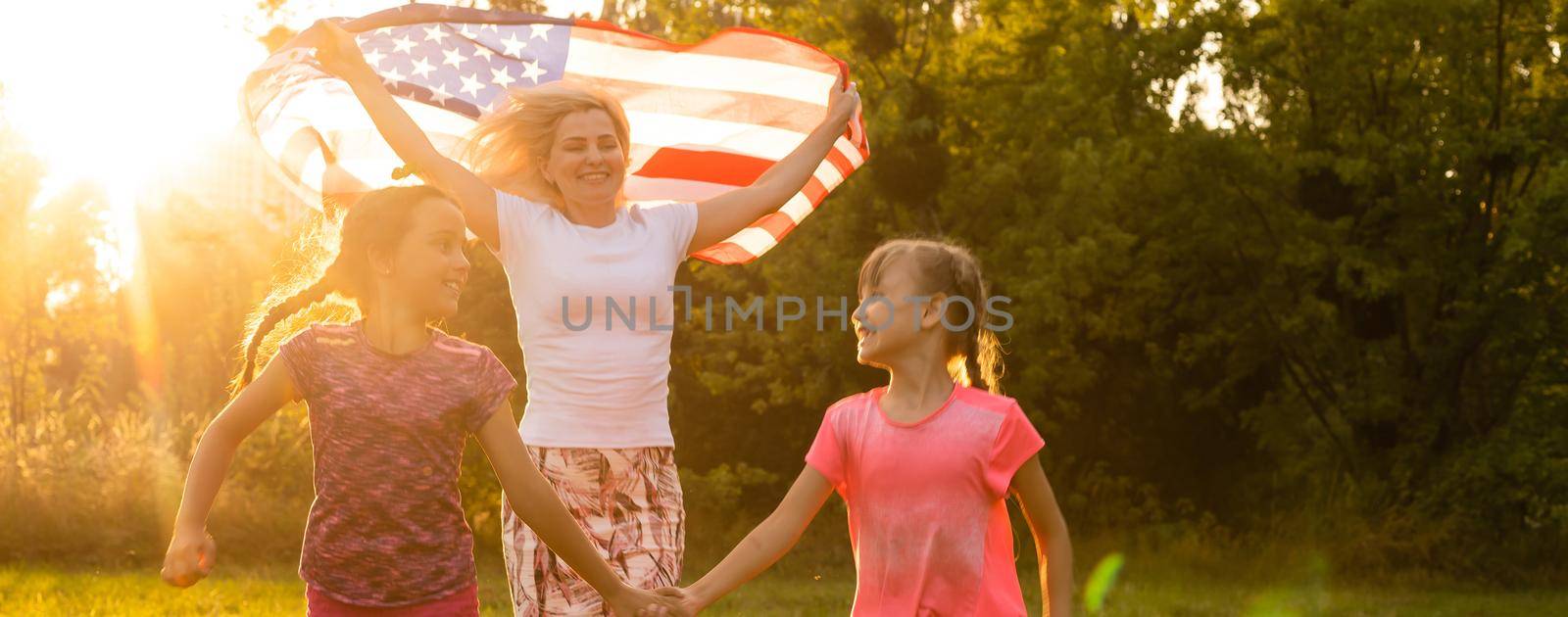 Happy family in field with USA, american flag on back. by Andelov13