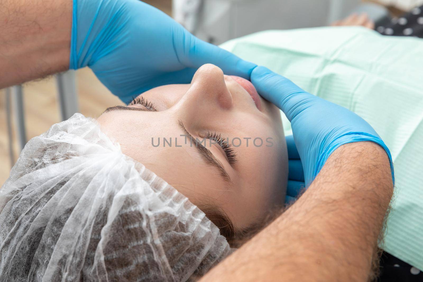 Male dentist looks at a jaw of female patient. Showing the bite to the doctor