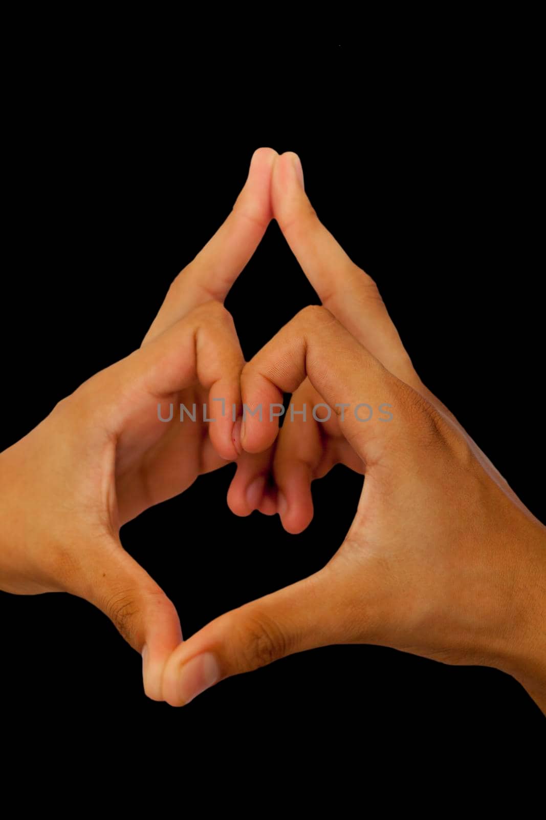 Shot of male hands doing Kalesvara mudra isolated on black background.