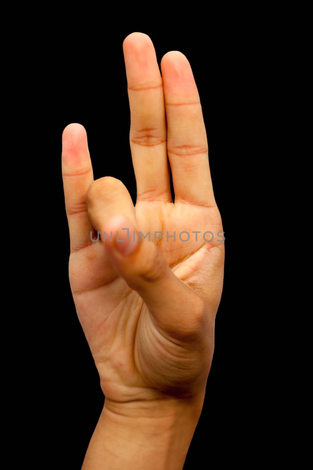 Prithvi mudra demonstrated by male hand isolated on black background.