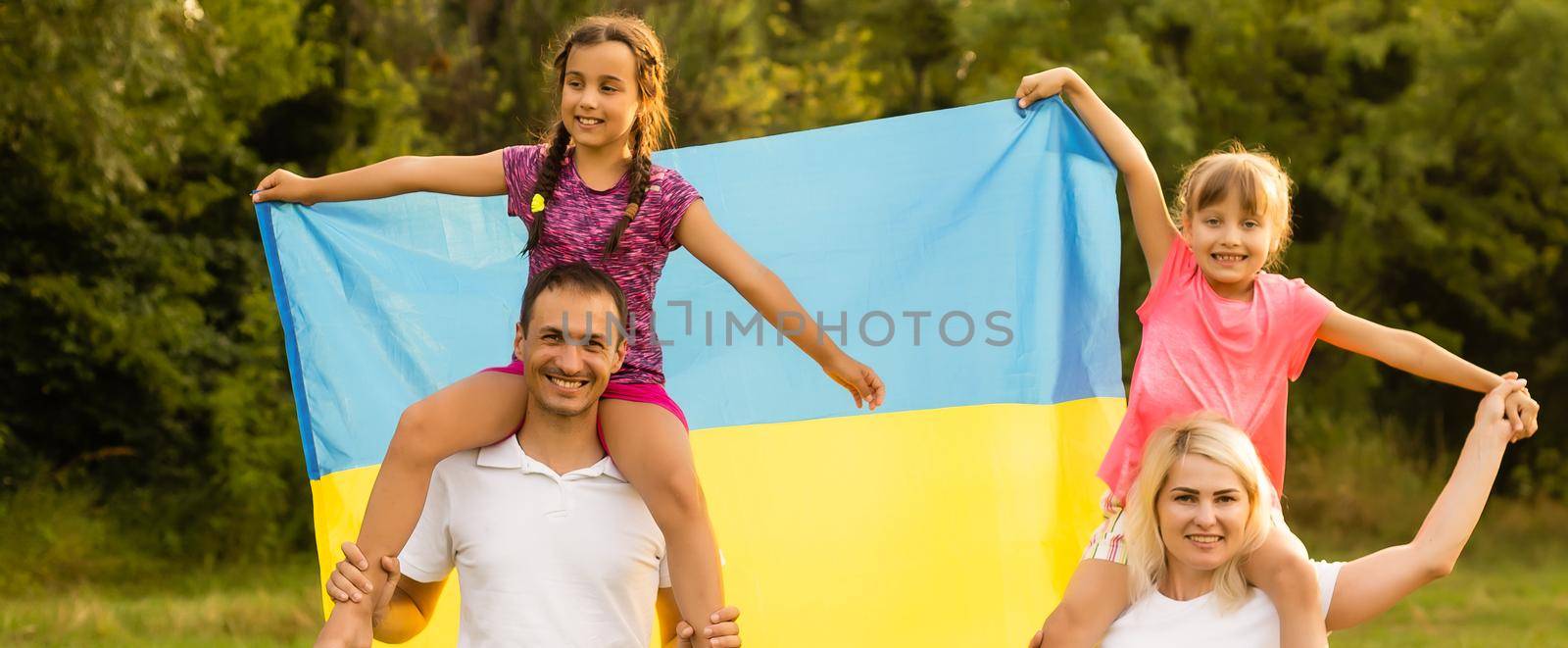 family with the flag of ukraine. Happy Independence Day of Ukraine. National Flag Day. Love for the homeland and symbols. Copy space. by Andelov13