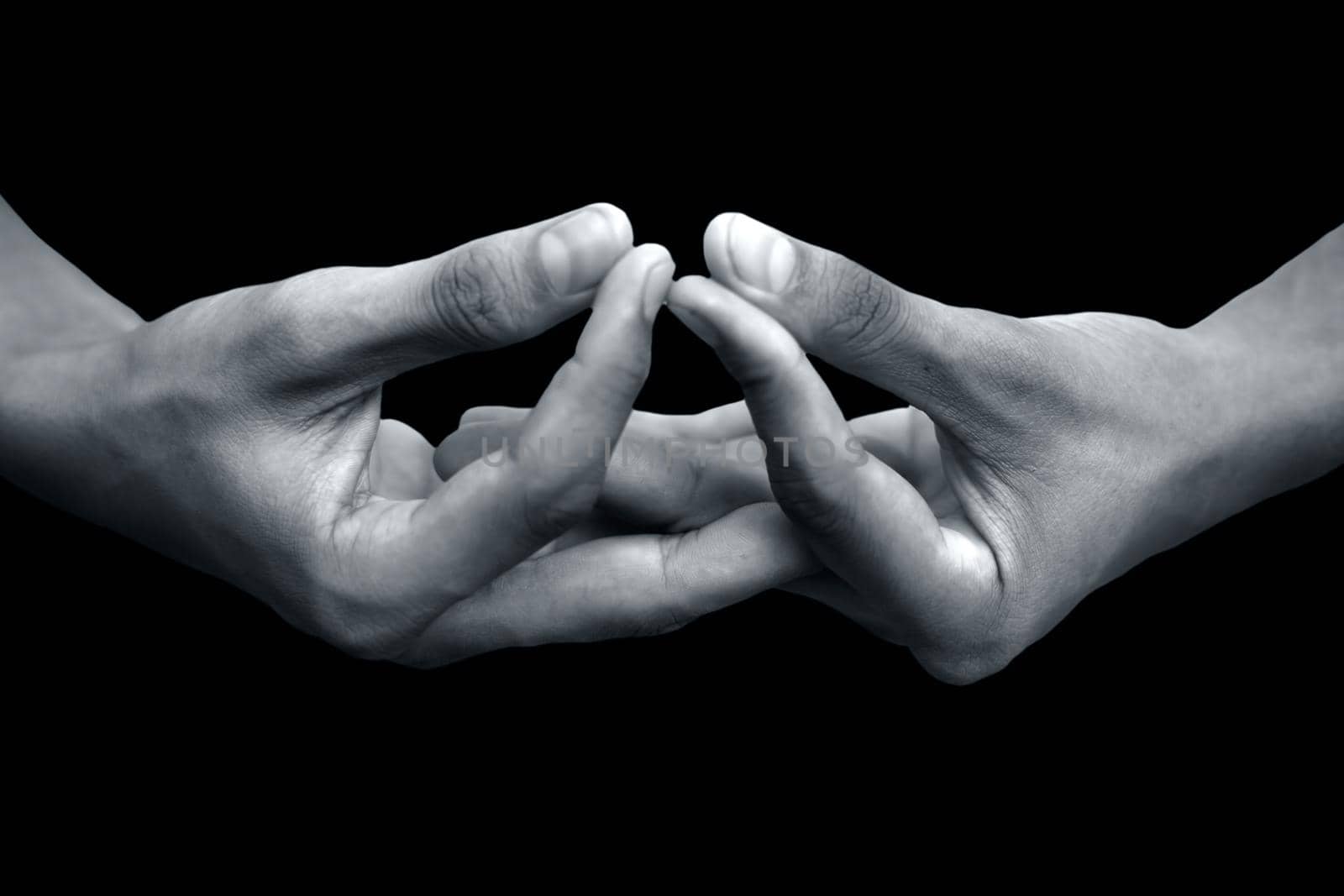 Mida-no Jouin Mudra demonstrated by male hands isolated on black background.