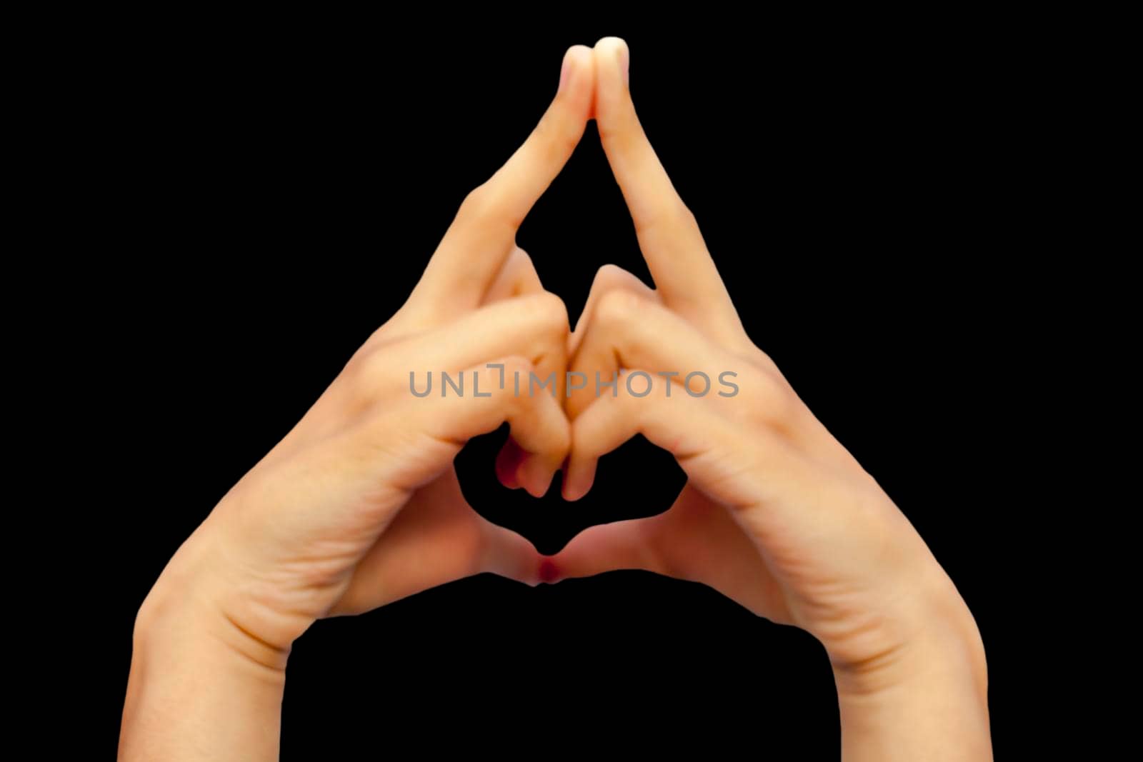 Shot of male hands isolated on black background demonstrating Kalesvara mudra.