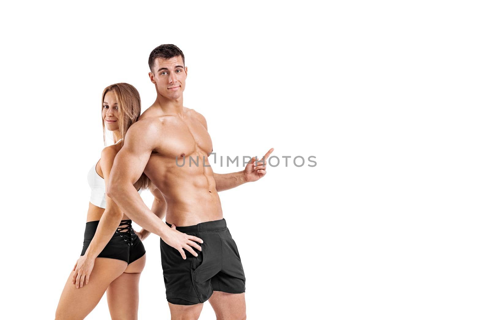 Fit couple at the gym shows on copy space isolated on white background . Fitness concept. Healthy life style. Mr and Mrs Fitness