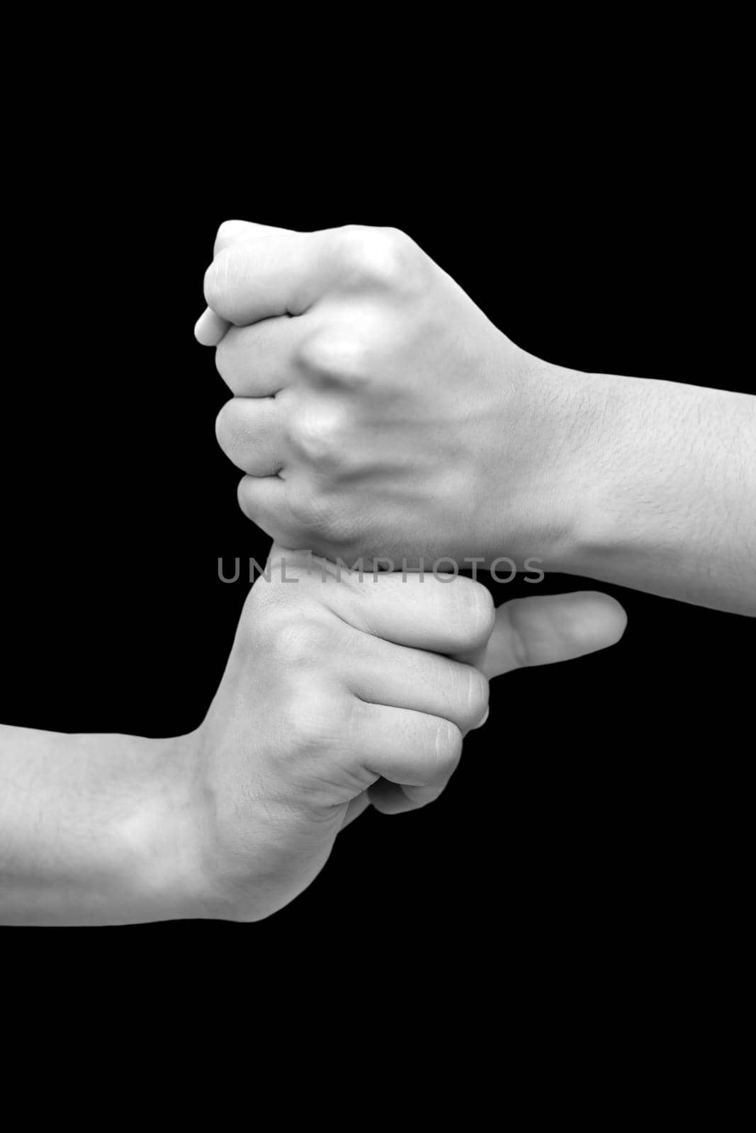 Shot of pair of hands doing Vajra mudra isolated on black background.