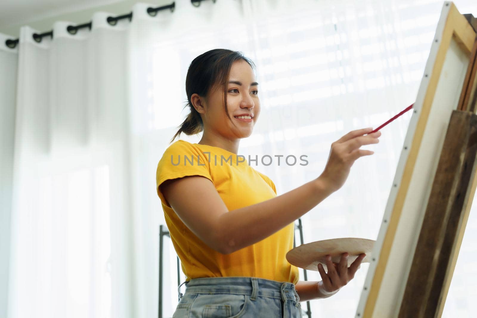 Portrait of an Asian woman designing art in her spare time. by Manastrong