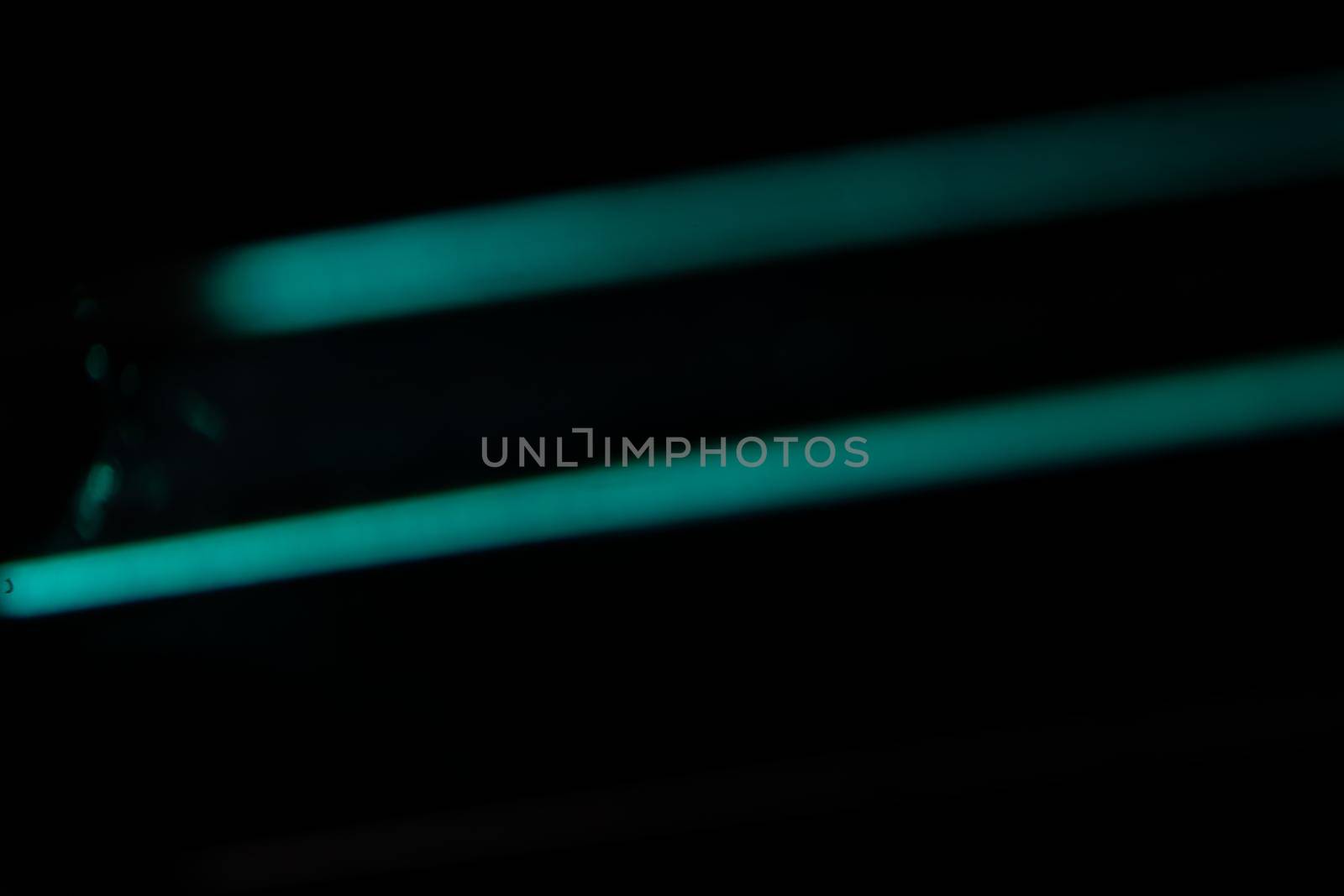 Blue light flare prism rainbow flares overlay effect on black background, light crossing crystals, prismatic sun catcher reflections rays. Abstract blurred colourful lens flare bokeh on dark by photolime