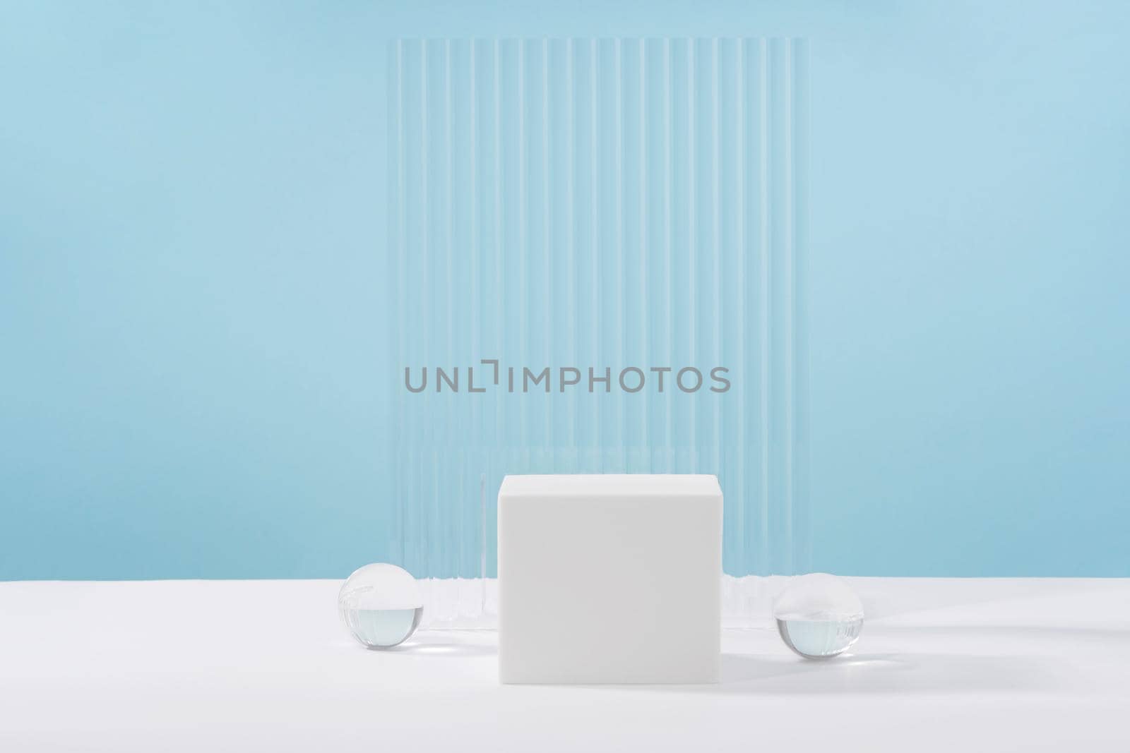 Acrylic plate, podium, background for cosmetic product packaging on blue backdrop with stylish props. Showcase for jewellery presentation, display for advertising, cosmetics branding scene by photolime