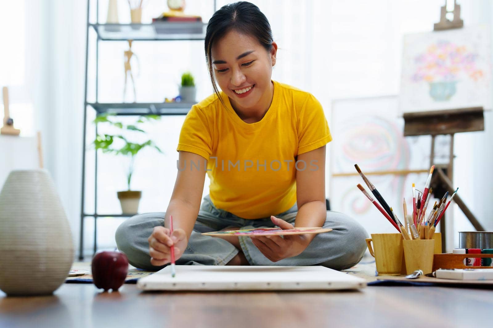 Portrait of an Asian woman designing art in her spare time. by Manastrong