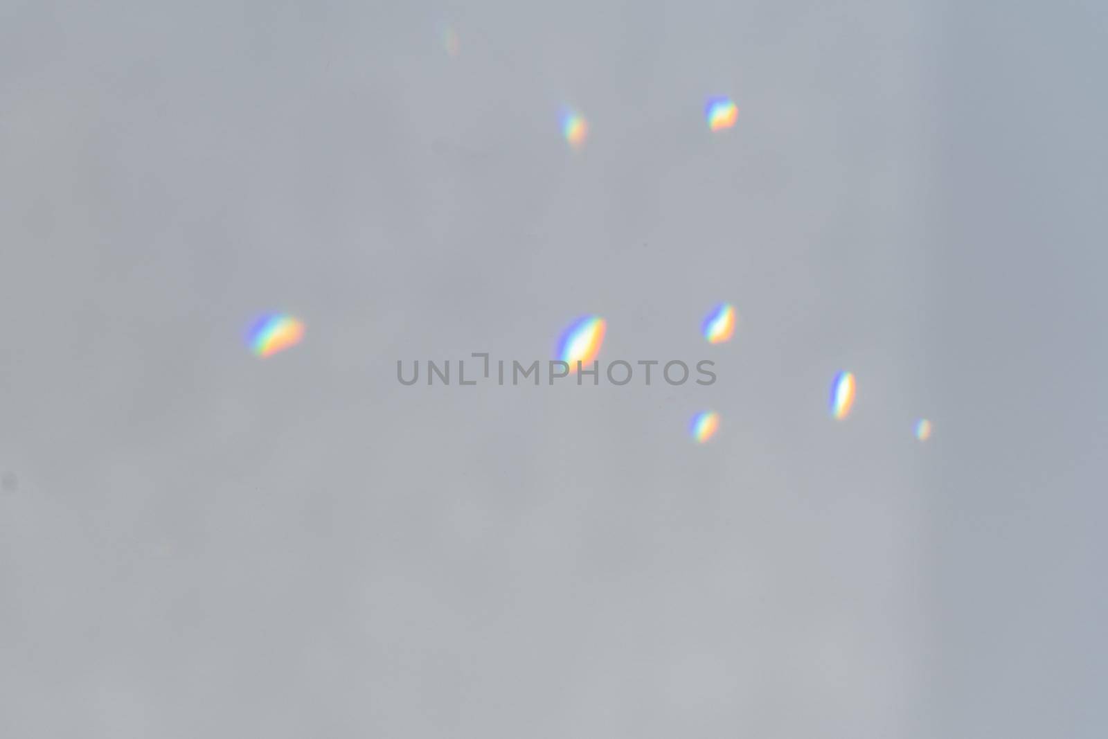 .Rainbow holographic shadow mock up, iridescent prismatic wallpaper. Abstract prism reflection, rays leaking through lens effect. Crystal light reflections for overlay mockup on light background.