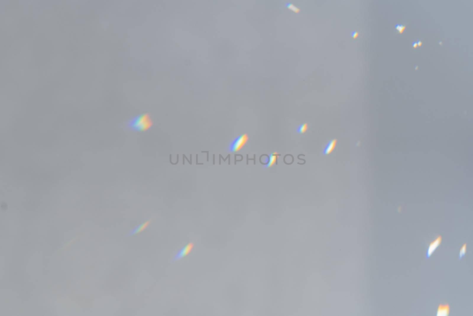 .Rainbow holographic shadow mock up, iridescent prismatic wallpaper. Abstract prism reflection, rays leaking through lens effect. Crystal light reflections for overlay mockup on light background.