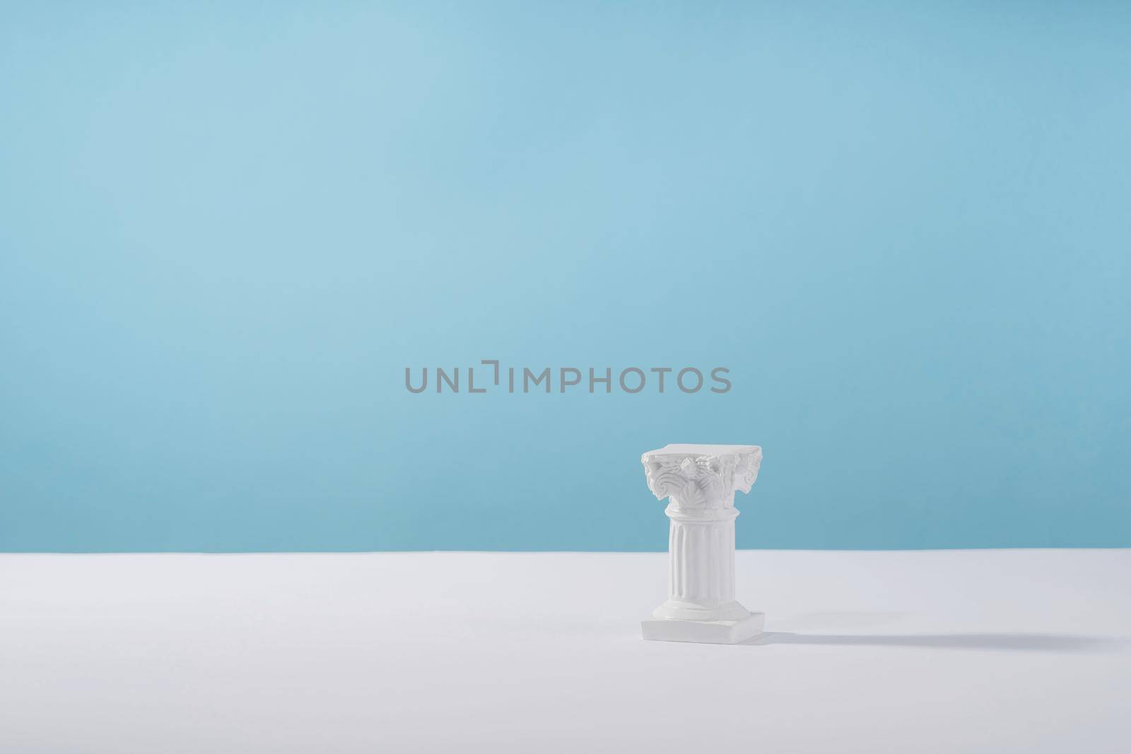 Cosmetic display podium platform roman marble column for product presentation, cosmetics geometric stand stylish props, mockup scene aesthetic on blue. Creative product stage by photolime