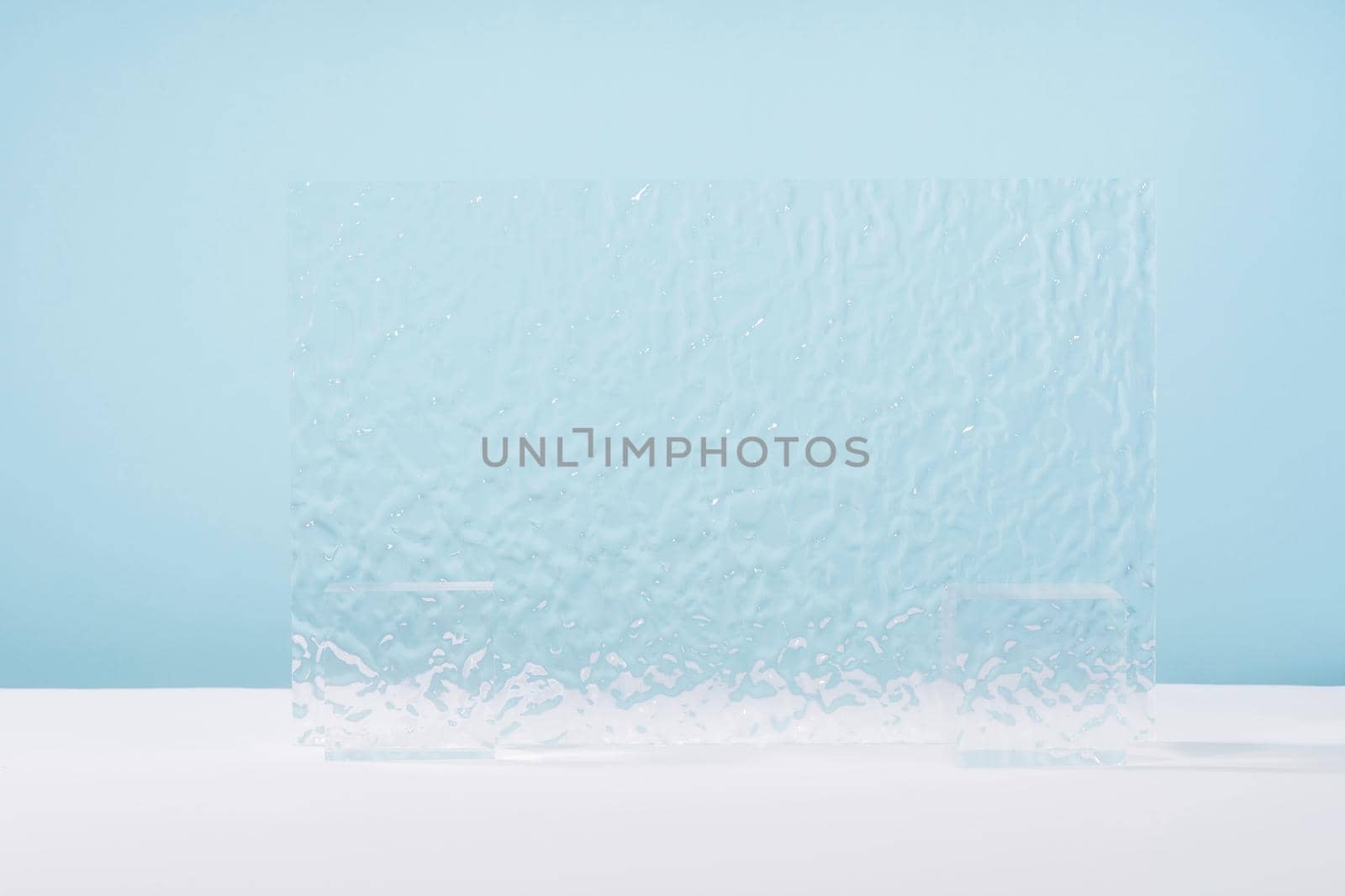 Acrylic ribbed plate, background for cosmetic product packaging on blue backdrop. Showcase for jewellery presentation, display for perfume advertising, cosmetics stand branding scene mockup by photolime