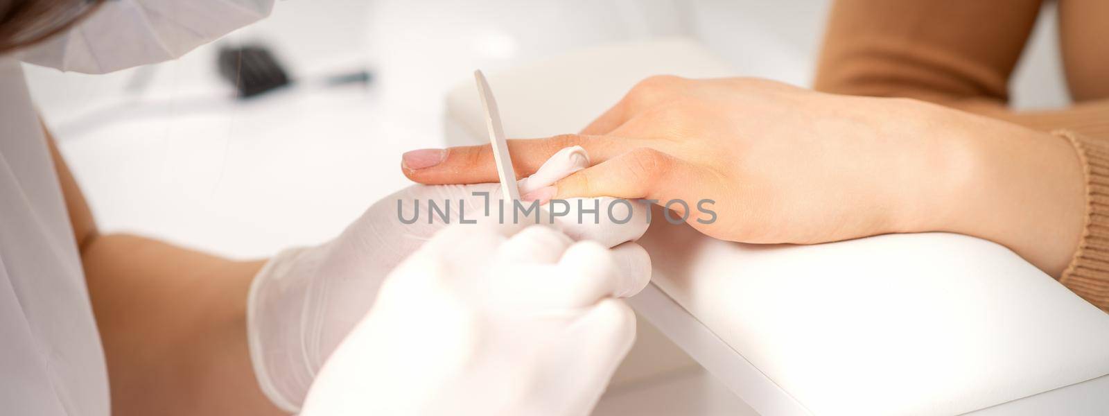 Hand receiving the nail file by okskukuruza