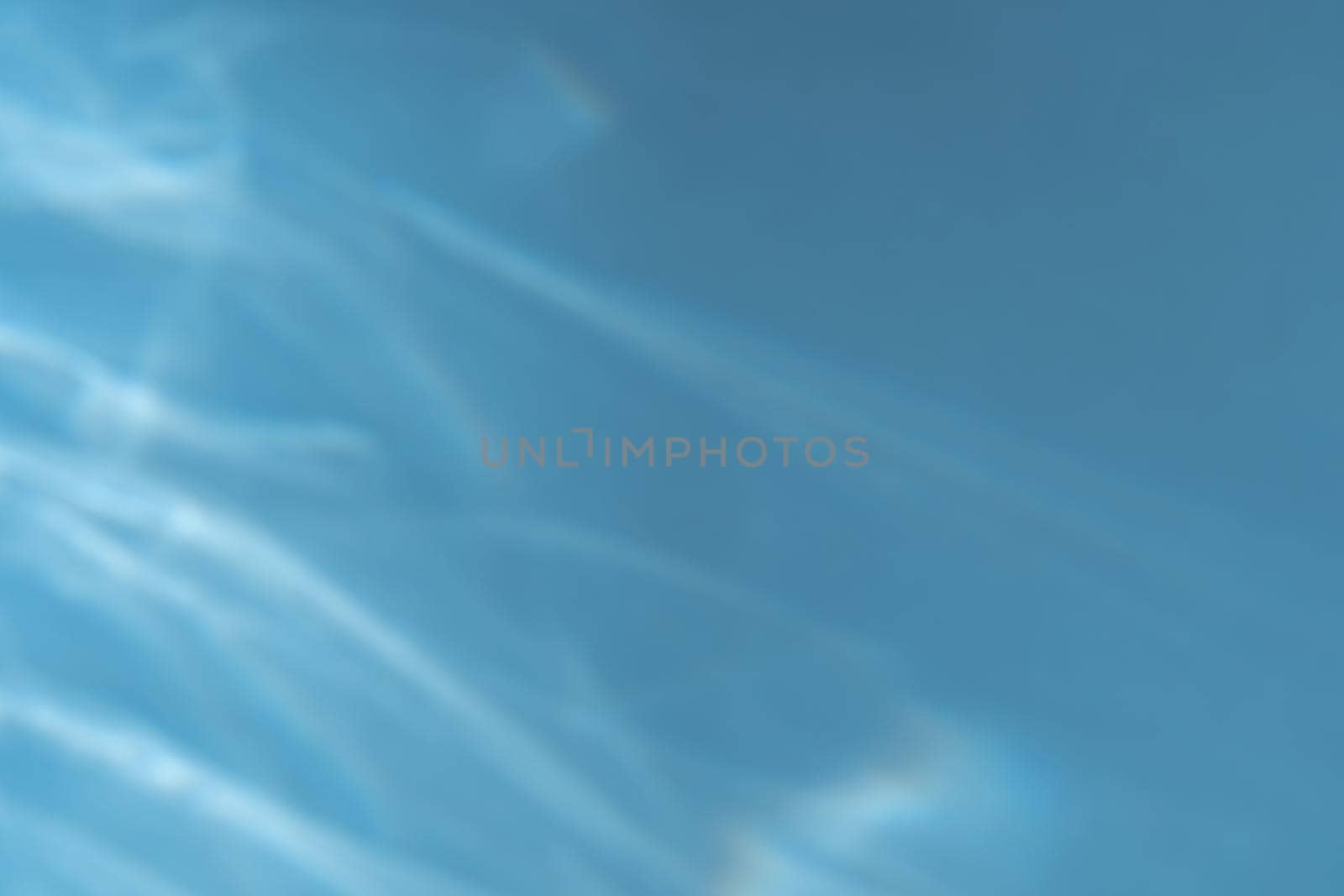 Caustic effect light refraction on blue wall overlay photo mockup, blurred sun rays refracting through glass prism with shadow. Abstract natural light refraction silhouette on water surface mock up.
