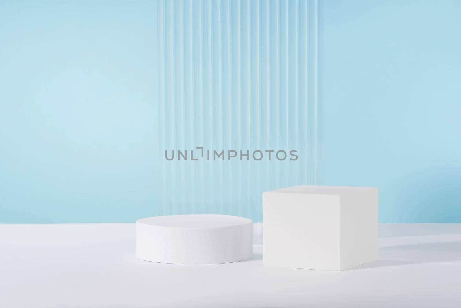 Acrylic ribbed plate, podium, background for cosmetic product packaging on blue backdrop. Showcase for jewellery presentation, display for perfume advertising, cosmetics branding scene by photolime