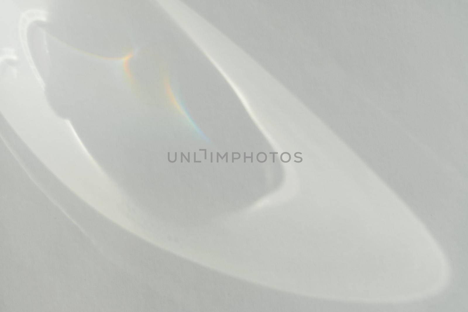 Caustic effect light refraction on white wall overlay photo mockup, blurred sun rays refracting through glass prism with shadow. Abstract natural light refraction silhouette on water surface by photolime