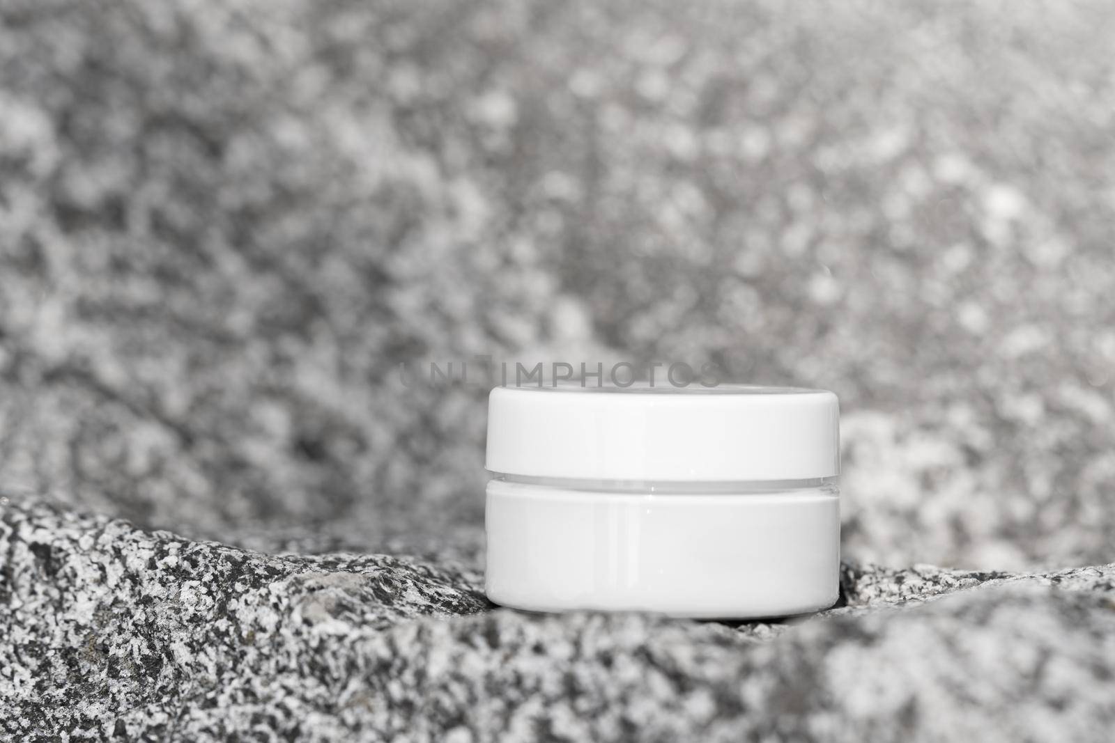 Cosmetic product mock up in jar on grey stone background. Lotion, hand or eye cream for skincare routine. Beauty packaging mockup. Front view. Cosmetics mockups conceptual still life by photolime