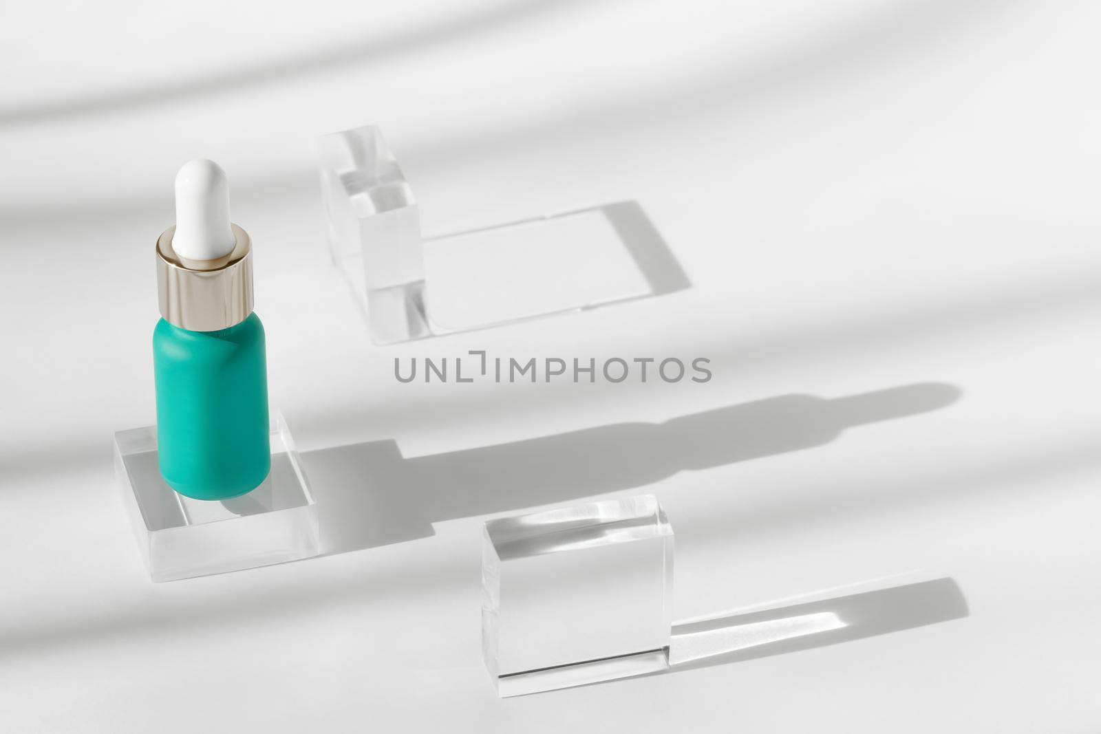 Serum essence mockup on acrylic solid block showcase on white background, shadow from sun, natural light. Geometric stand for cosmetics, product presentation, cosmetic bottle for skincare concept