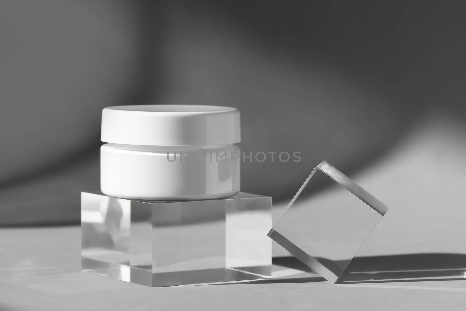 Cream lotion cosmetics showcase presentation mockup. White creme cosmetic jar on acrylic geometric pedestal podium block, product packaging with shadows from windows, Front view
