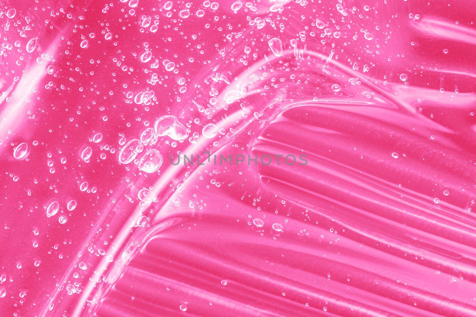 Gel serum liquid, cream with collagen and retinol, ceramide sample. Hyaluronic acid toner with retinol and ceramide, jelly texture cosmetic product. Pink mask smear smudge. Close-up, macro.