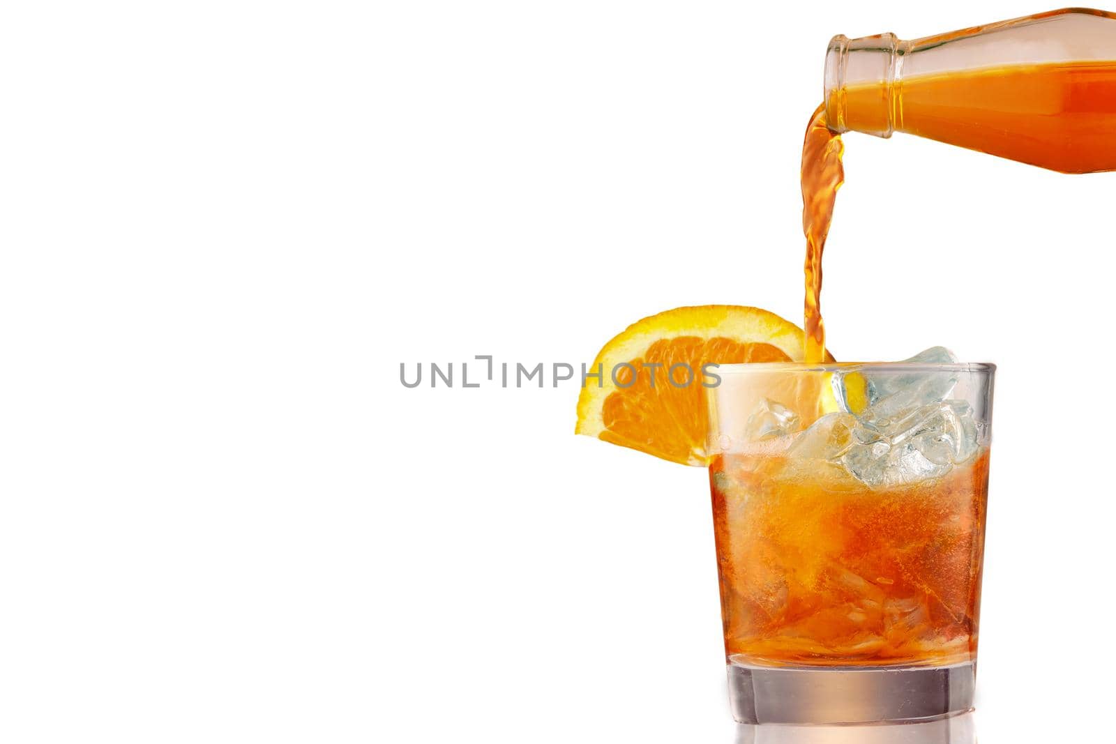 Glass of iced cold aperol spritz cocktail decorated with slices of orange. Aperitif, making coctail, pouring liquid into glass full of ice, isolated on white background. by photolime