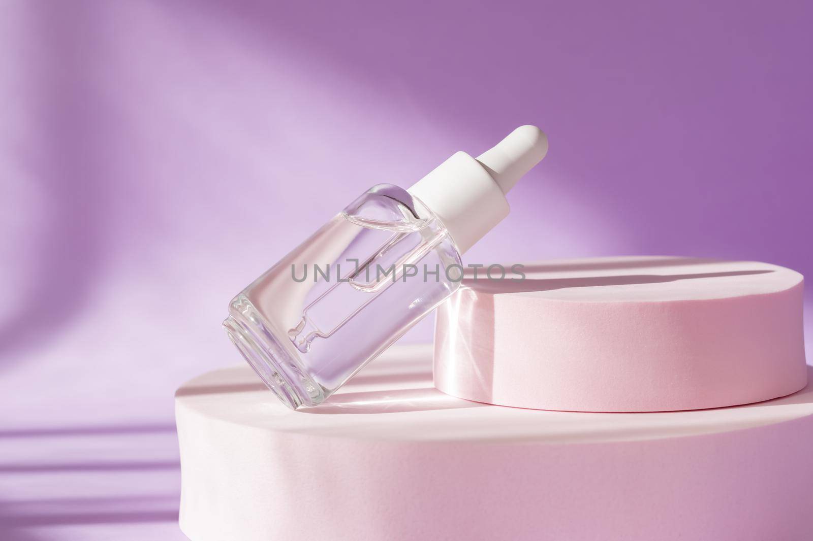 Cosmetic transparent bottle serum mockup on purple background. Modern packaging with podium, sunlight, shadow on pink with natural light. Product presentation display. Hyaluronic acid serum texture