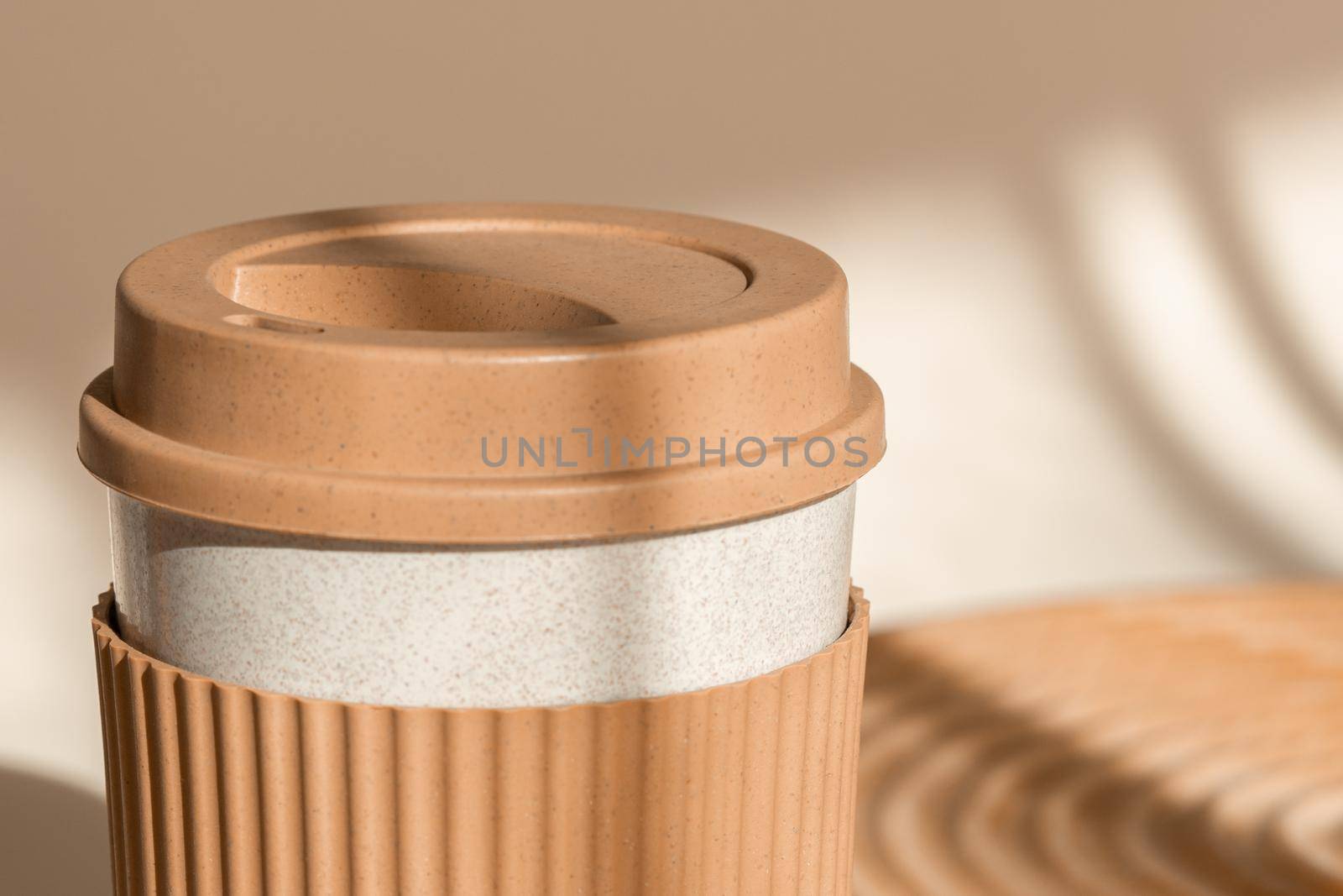 Reusable cup, biodegradable travel plastic coffee mug take away. Bamboo eco friendly cup. Zero waste, sustainability concept. Close up view, sustainable lifestyle by photolime