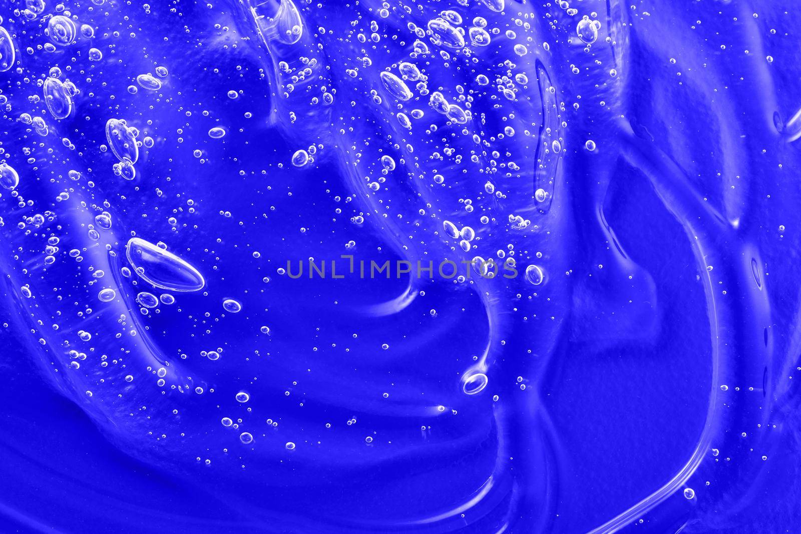 Cosmetic blue gel texture with bubbles. Hyaluronic acid clear serum sample. Liquid antibacterial disinfect smear smudge. Skincare moisturizing product background. Sanitizer swatch. by photolime