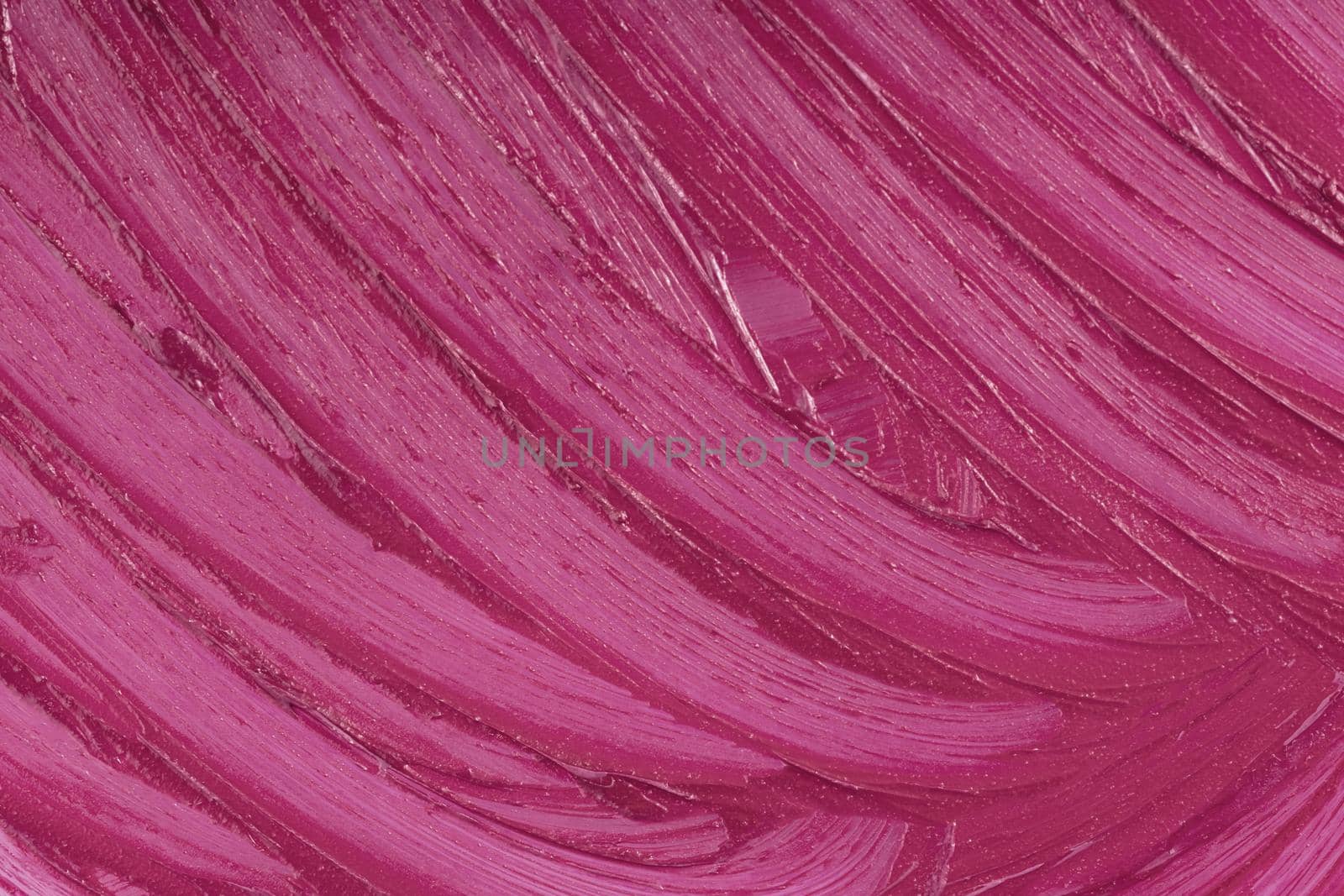 Marsala beauty product sample closeup. Purple cosmetics smear pattern background. Liquid lipstick cosmetic. Pink swatch matt backdrop. Makeup creamy texture. Creamy stroke