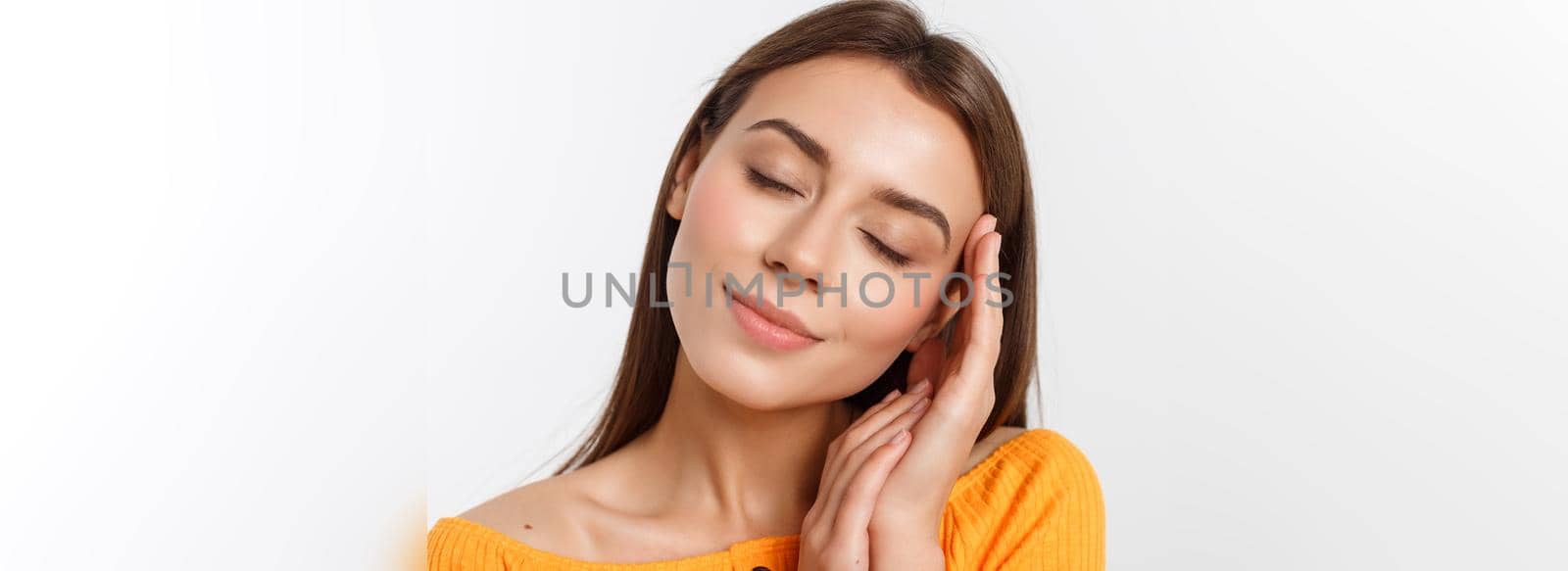 friendly smiling young woman with beatiful face portrait studio shot.