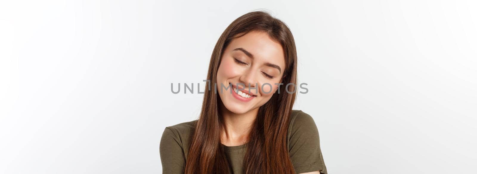 Portrait of a beautiful young woman looking at the camera and smiling, isolated on a white background. by Benzoix