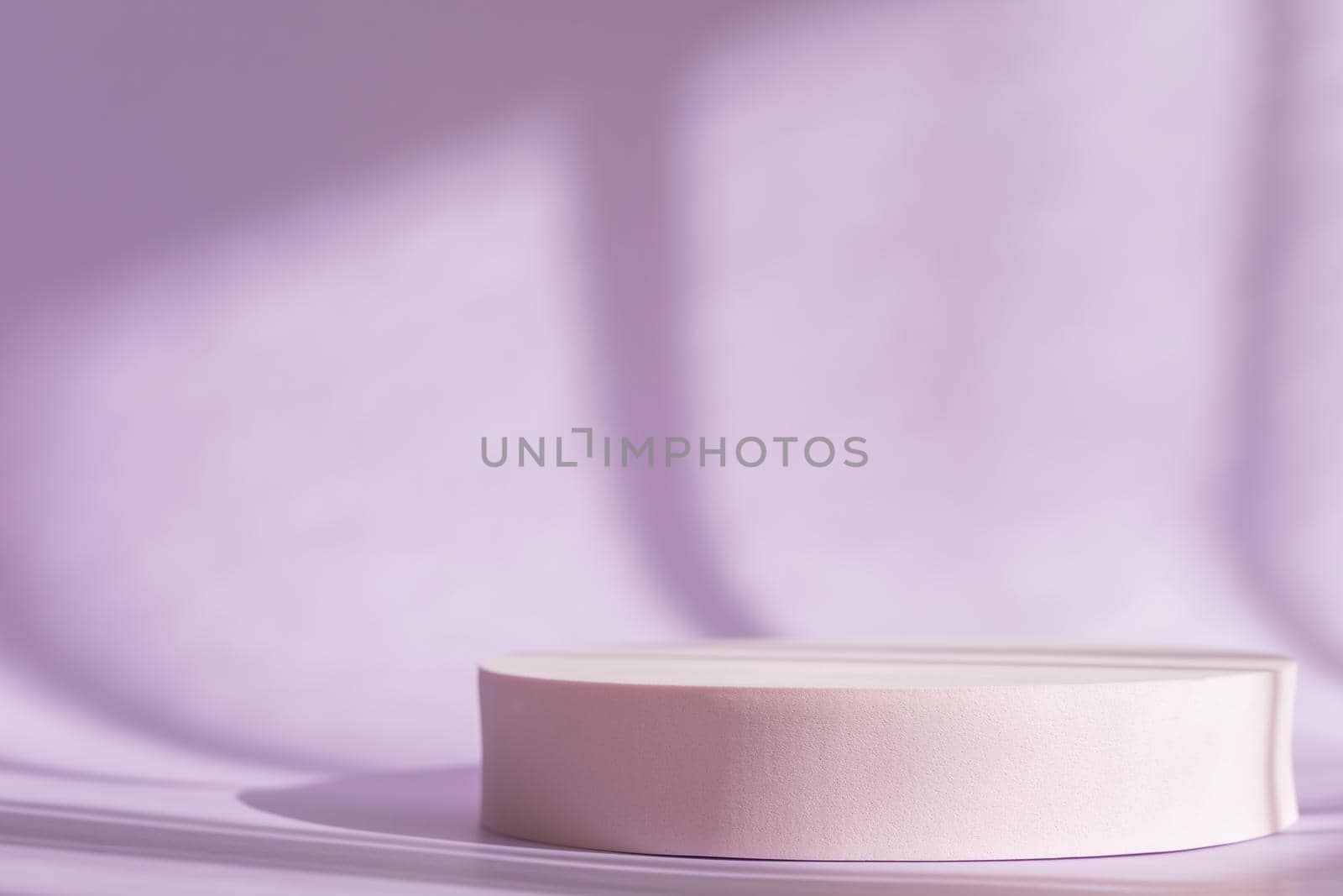 Lilac backdrop with pink round podium, display, mockup. Cosmetic product presentation with shadows and light from windows. Window natural shadow overlay effect on purple surface by photolime