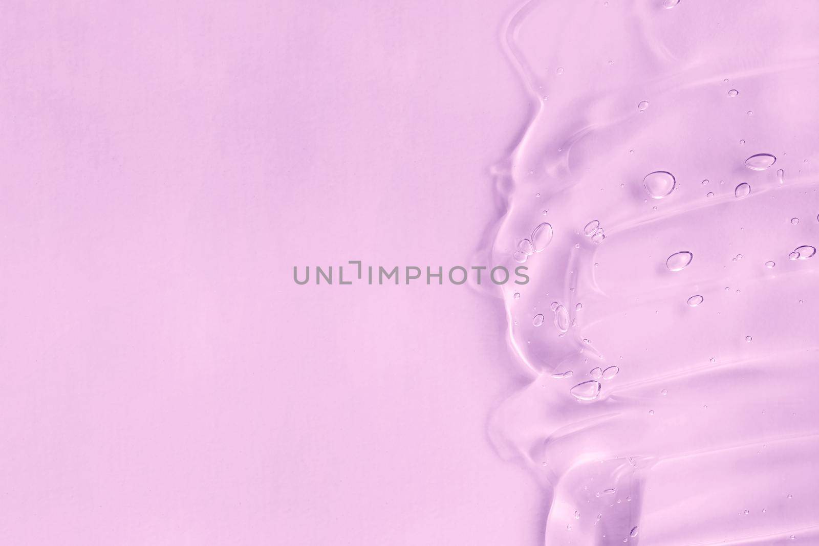Cosmetic cream transparent purple liquid gel sample swatch. Hyaluronic acid for skin care with collagen and retinol. Pink gel smudge on purple background. Skincare lotion face serum.