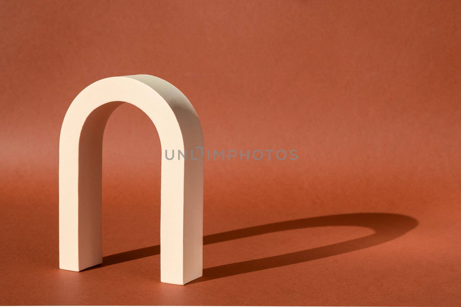 Cosmetic art deco arch podium display pedestal stand. Fashion geometric arch backdrop for product presentation with shadow from sun. Abstract minimal template stage. Modern scene mockup showcase