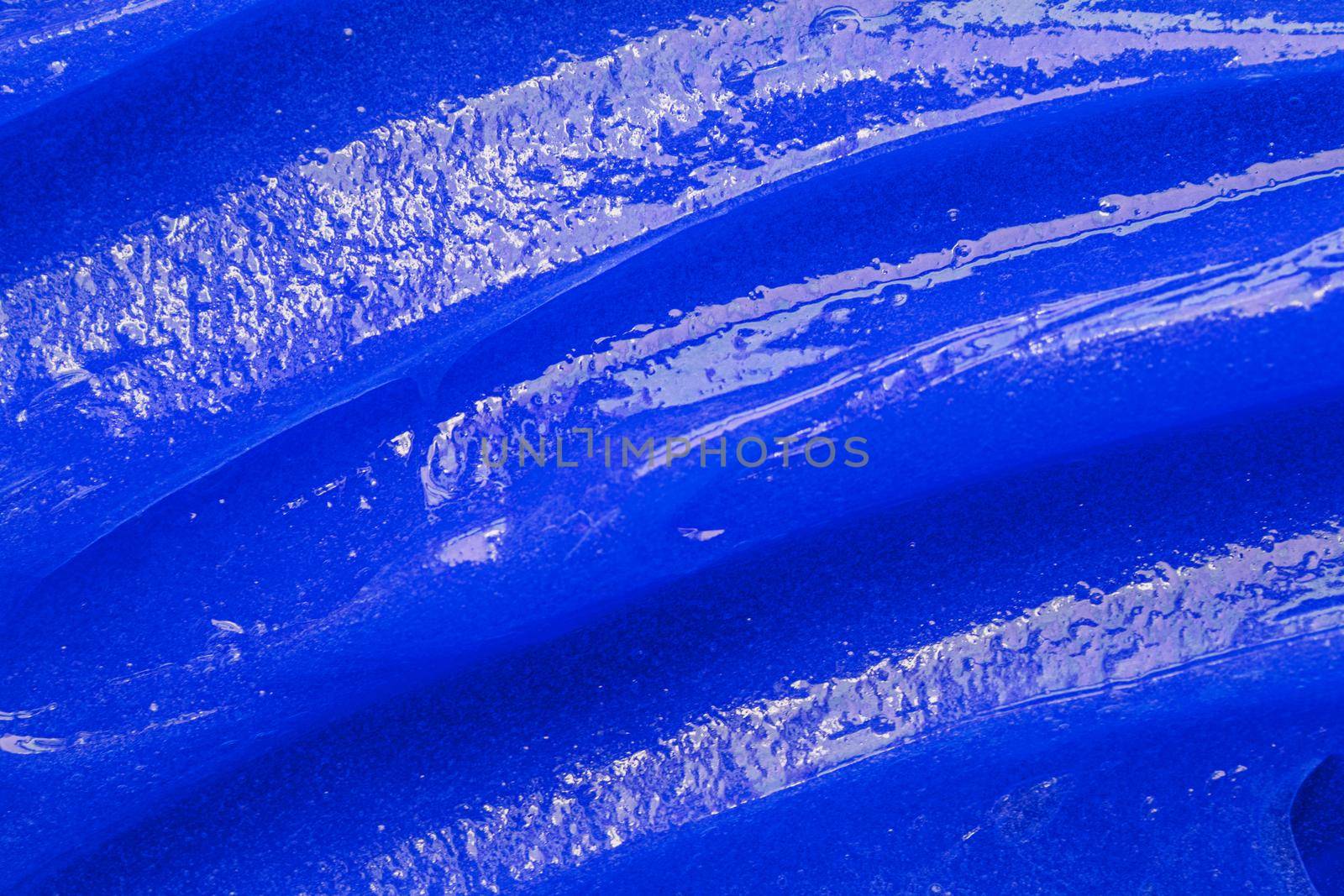 Blue gel texture. Cosmetic clear liquid cream smudge. Skin care product sample closeup. Toothpaste or wax by photolime