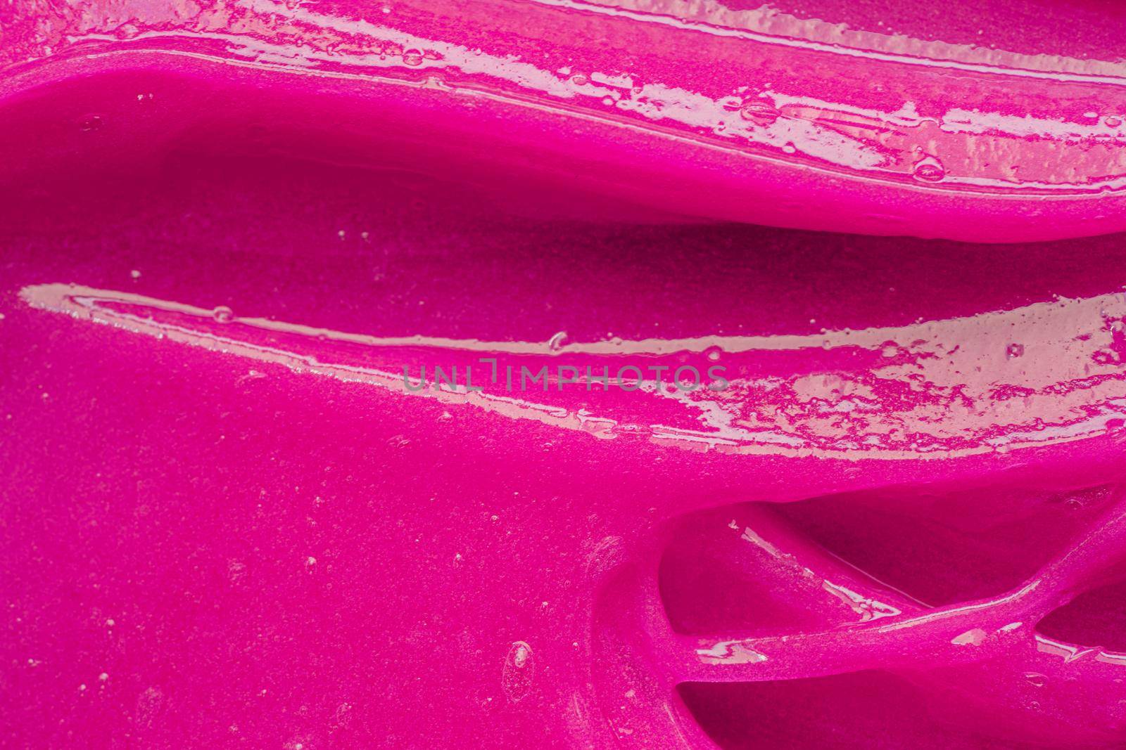 Pink gel texture. Cosmetic clear liquid cream smudge. Skin care product sample closeup. Toothpaste or wax by photolime