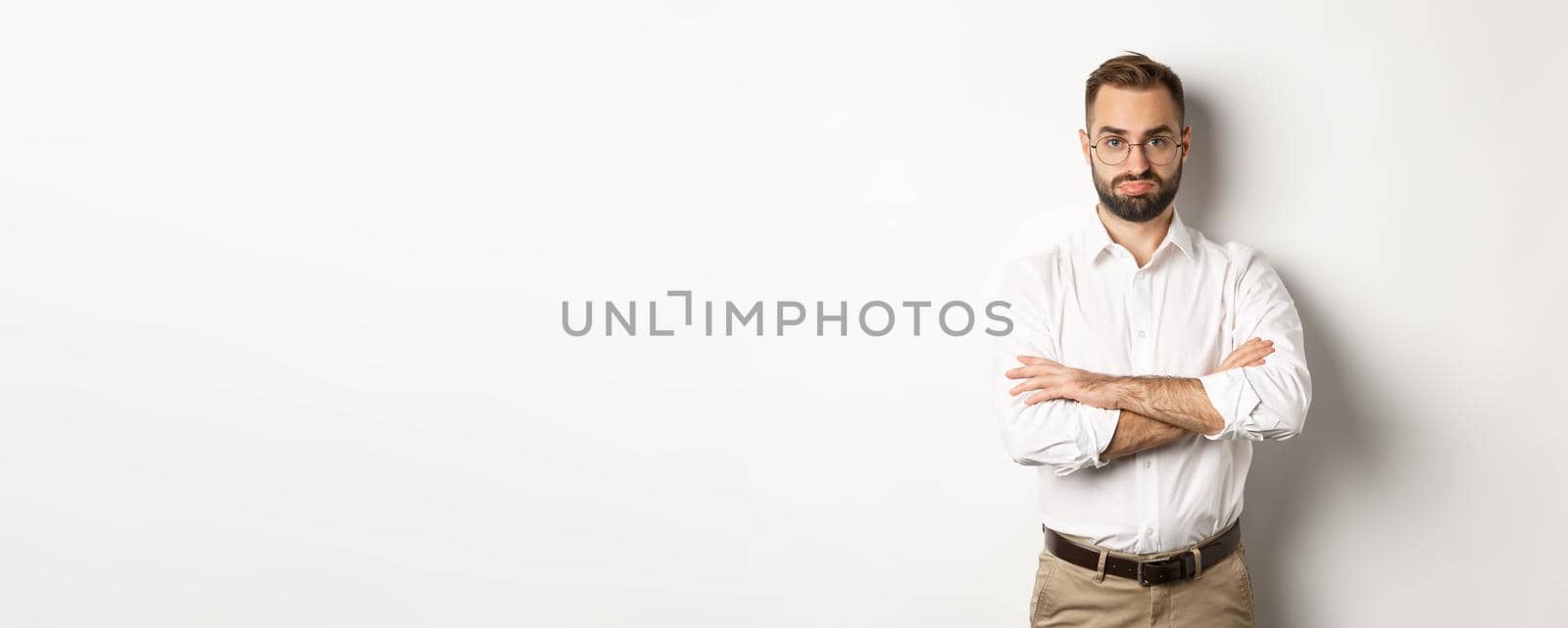 Disappointed businessman pouting, standing displeased against white background by Benzoix