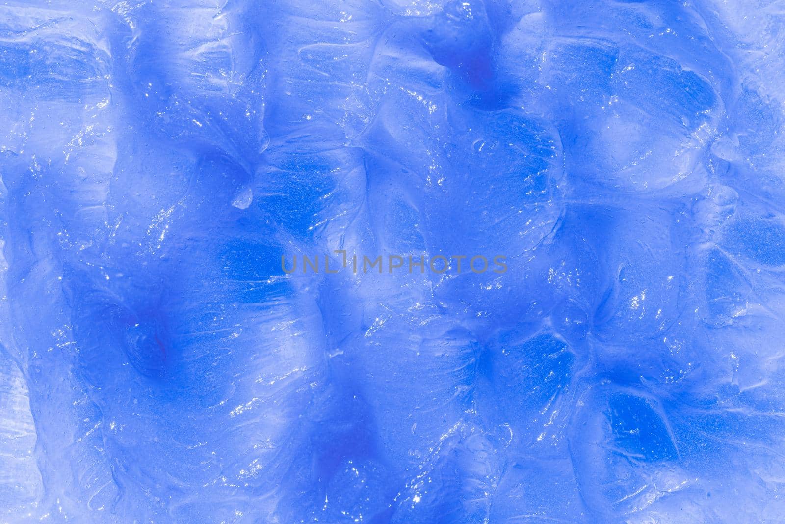 Blue cosmetic smear background. Creamy balm texture product closeup. Moisturising and cleaning beauty product sample swatch.