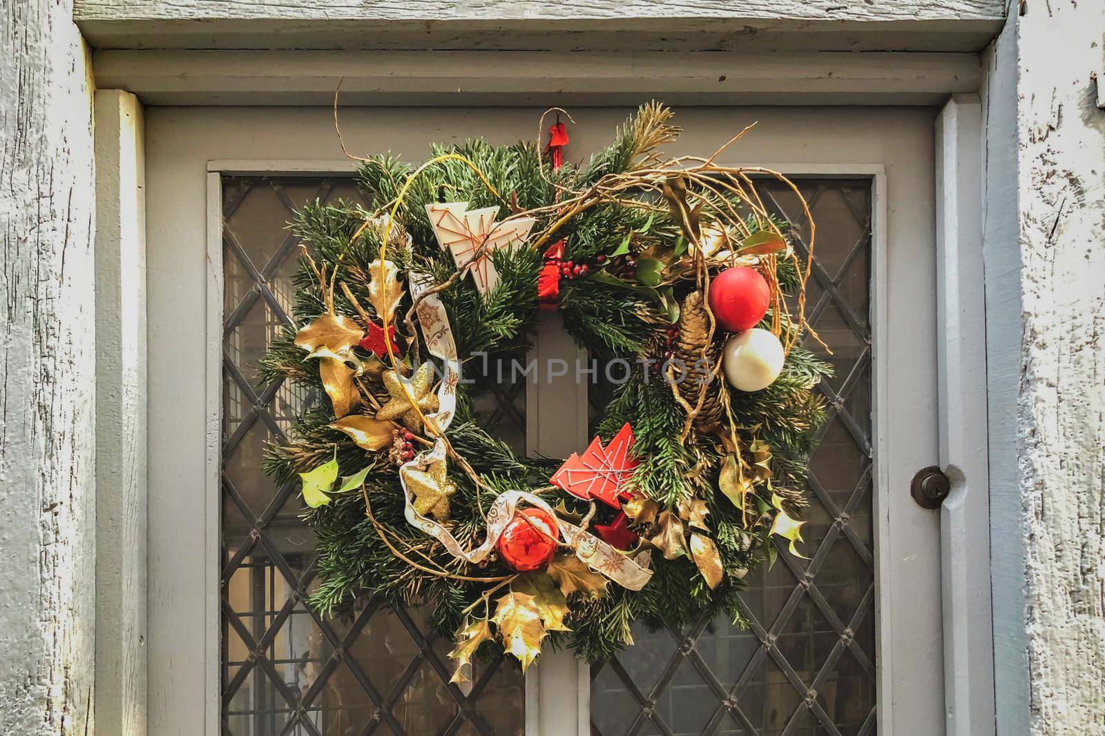 Gold christmas wreath on a gray shabby door
