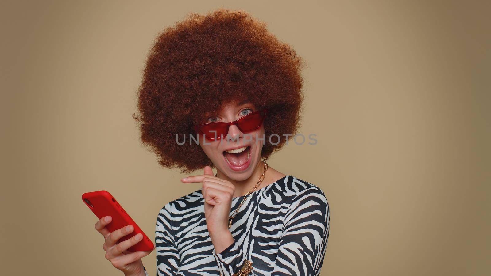 Pretty young female girl using smartphone typing new post on web, browsing, searching, addiction of social networks, show thumbs up like, positive feedback, recommends wifi cellular connection 5G